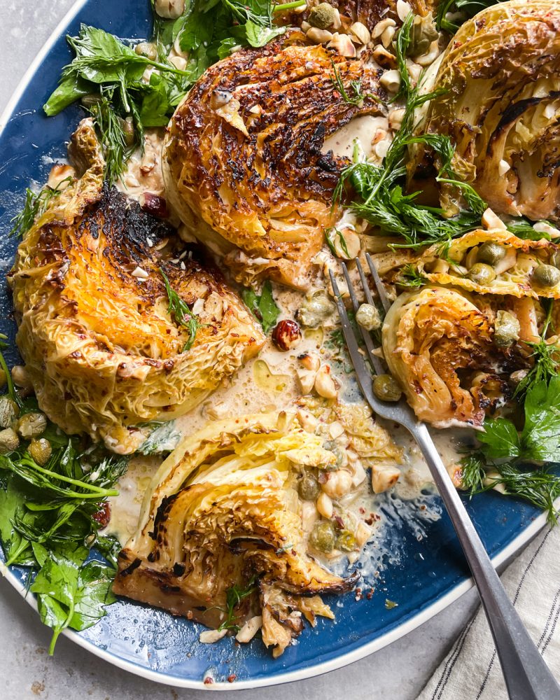 Braised Cabbage with Anchovy Butter, Tahini and Herb & Caper Salad by