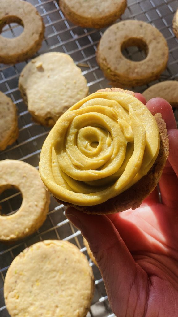 Pistachio Shortbread Cookies with White Chocolate Pistachio Ganache by Fidelia Grace - FoodSocial