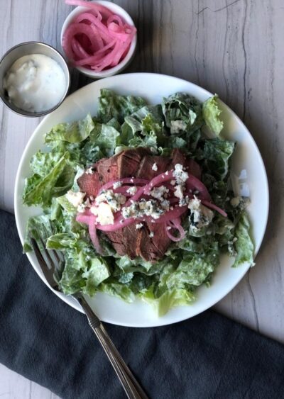 Steak and Blue Cheese Salad Topped with Marinated Red Onions