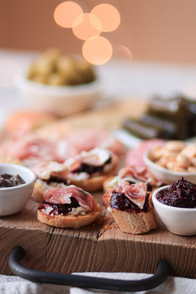 Garlic & Rosemary Crostini with Goat Cheese, Hot Pepper Jam, and Prosciutto