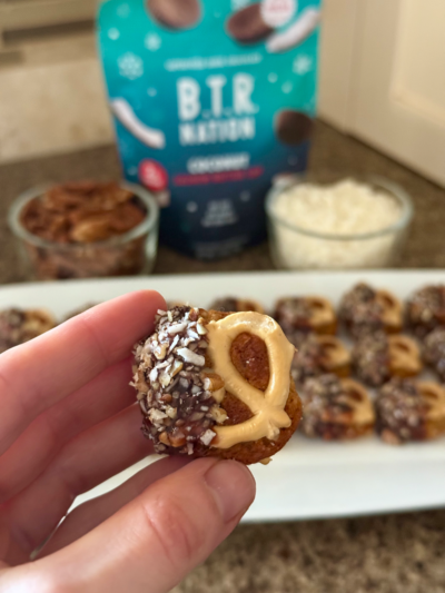 salted chocolate caramel dipped coconut & pecan protein cookie pretzel sandwich
