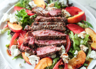 Herb-Crusted Grilled Ribeye with Peach and Heirloom Tomato Salad